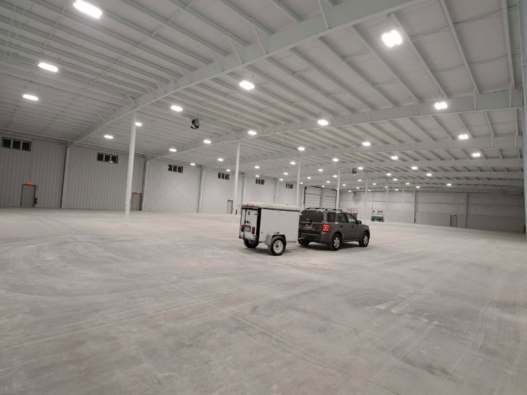 Warehouse ceiling and steel sprayed bright white with dry fall paint