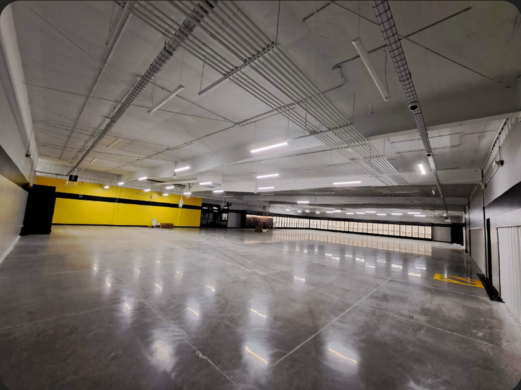 Finished Dollar General interior with white ceiling and bright yellow accent wall