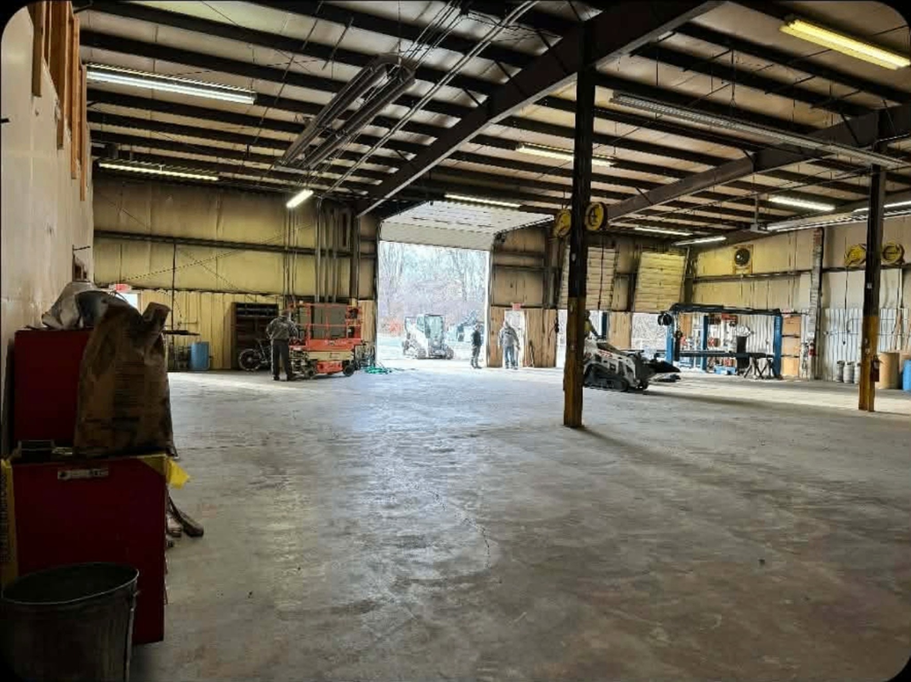Dark, dingy shop ceiling and steel before dry fall spraying